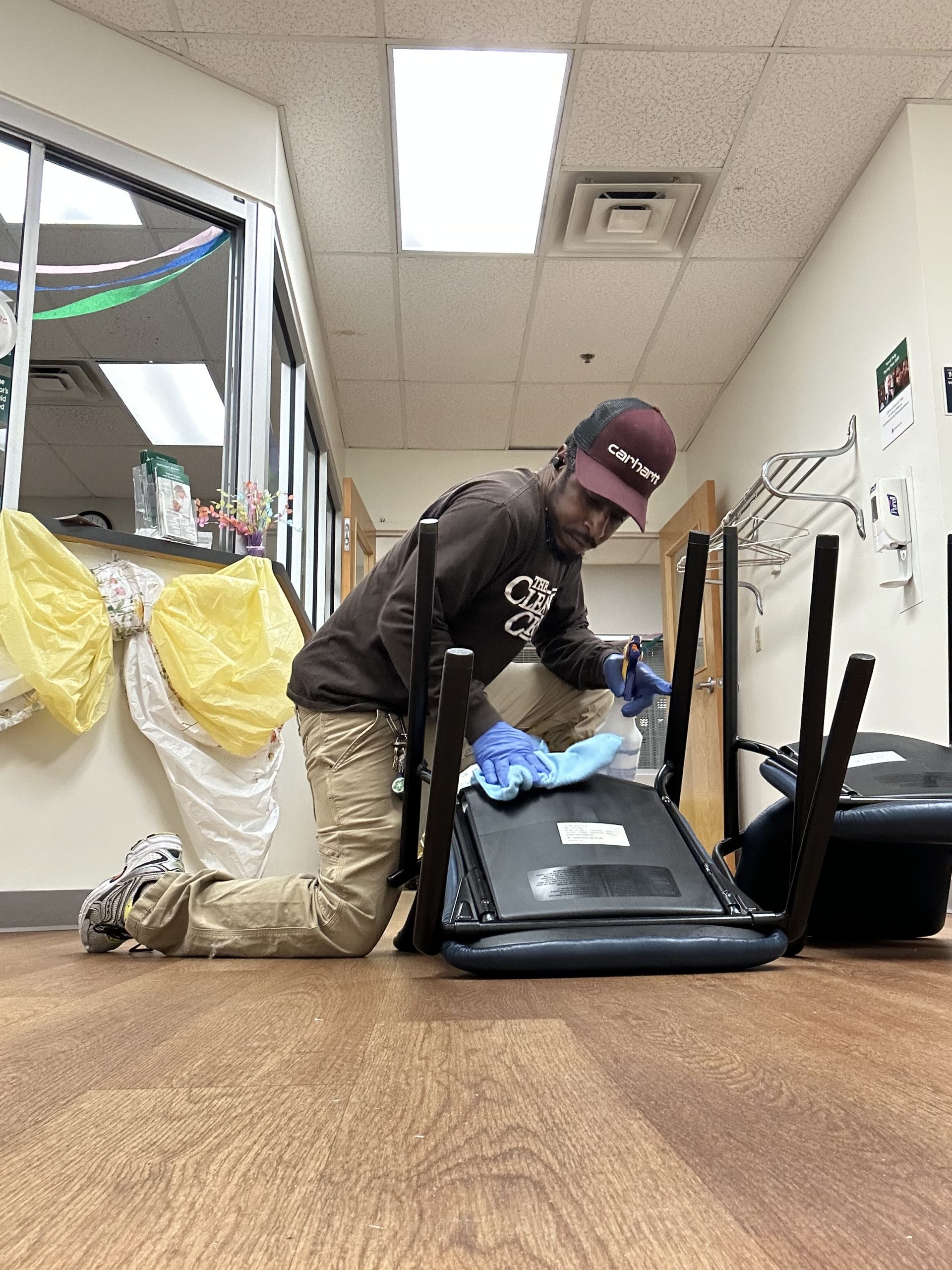 Team member wiping down a waiting-room chair