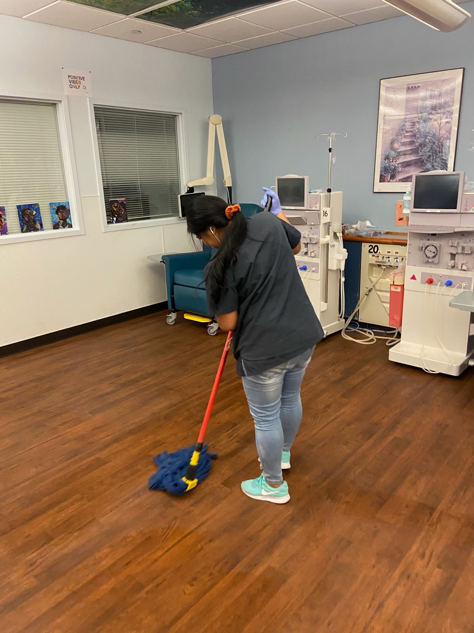 Team member mopping a dialysis treatment-area floor