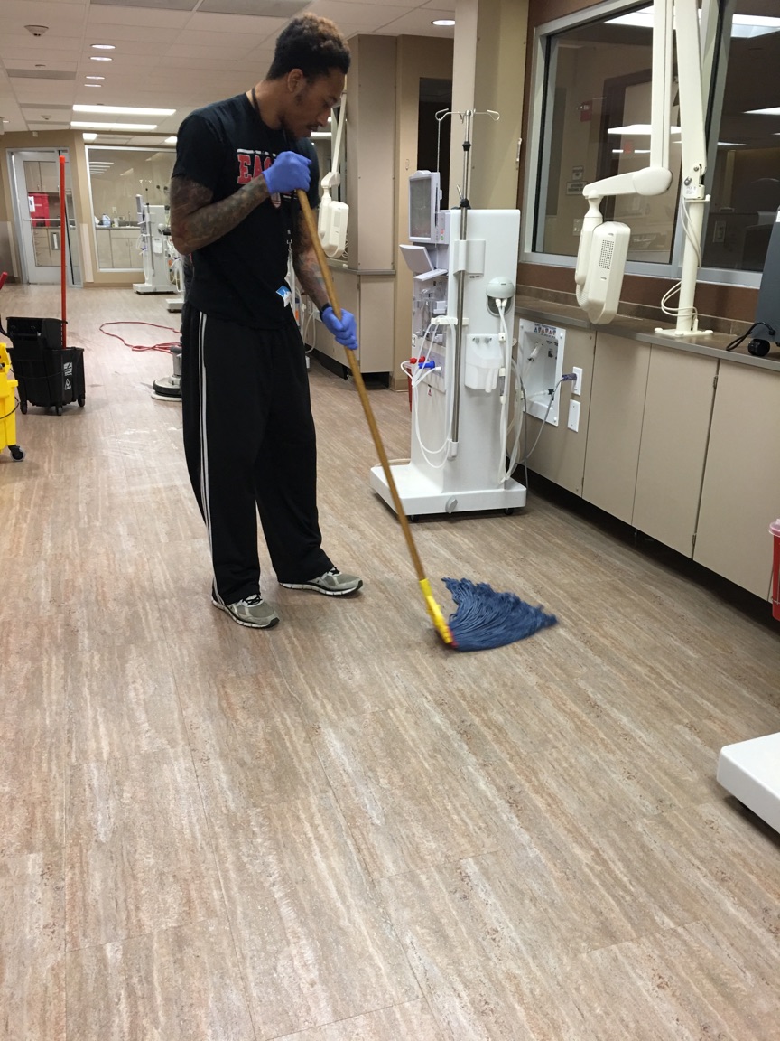 Team member mopping a dialysis treatment floor