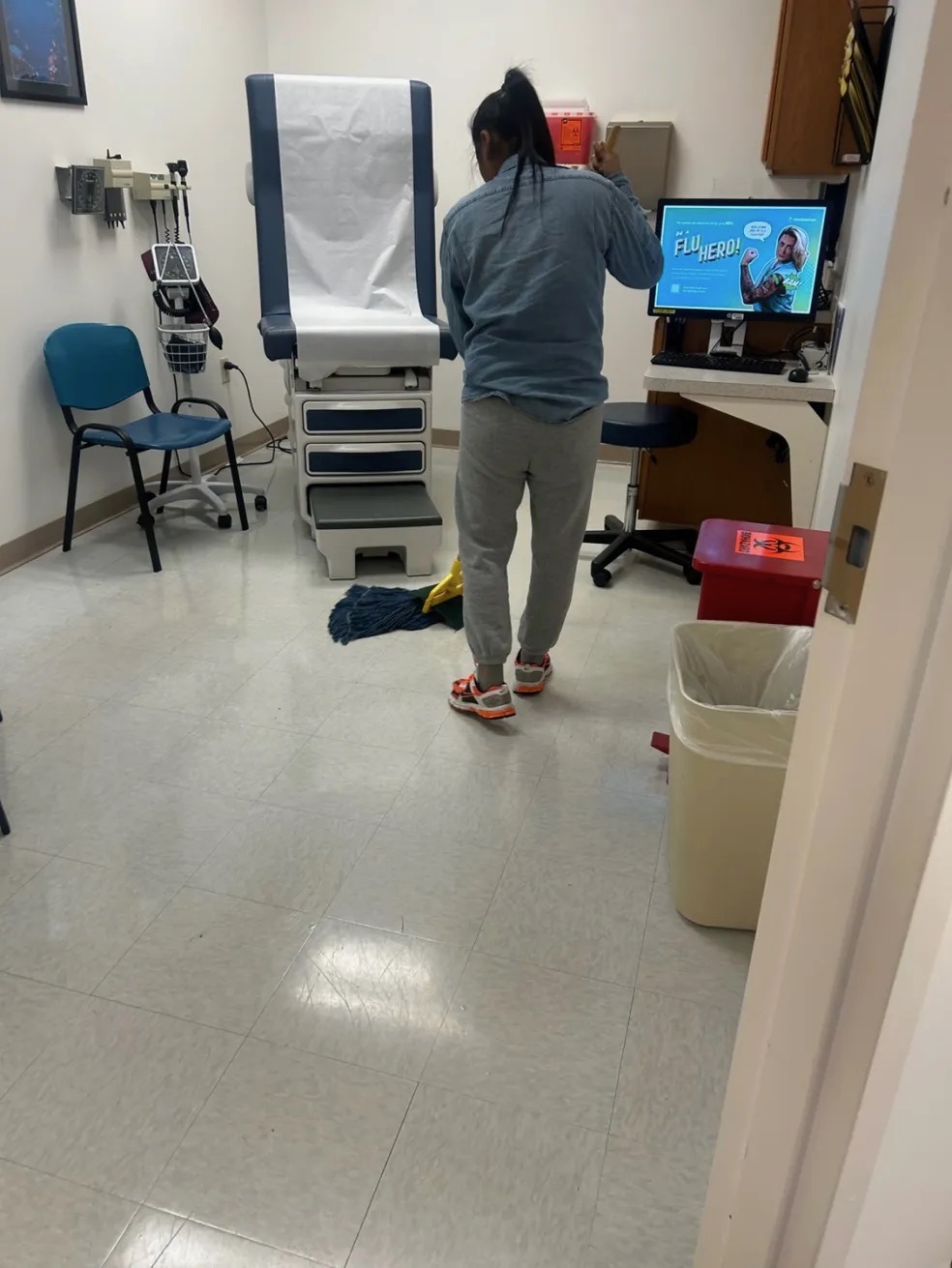 Team member mopping a medical exam room