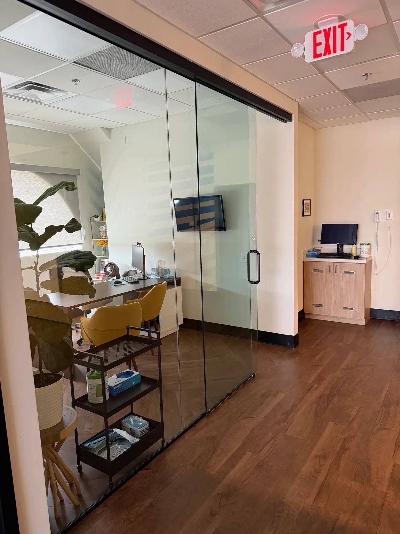 Glass-walled office suite with clean hardwood floors