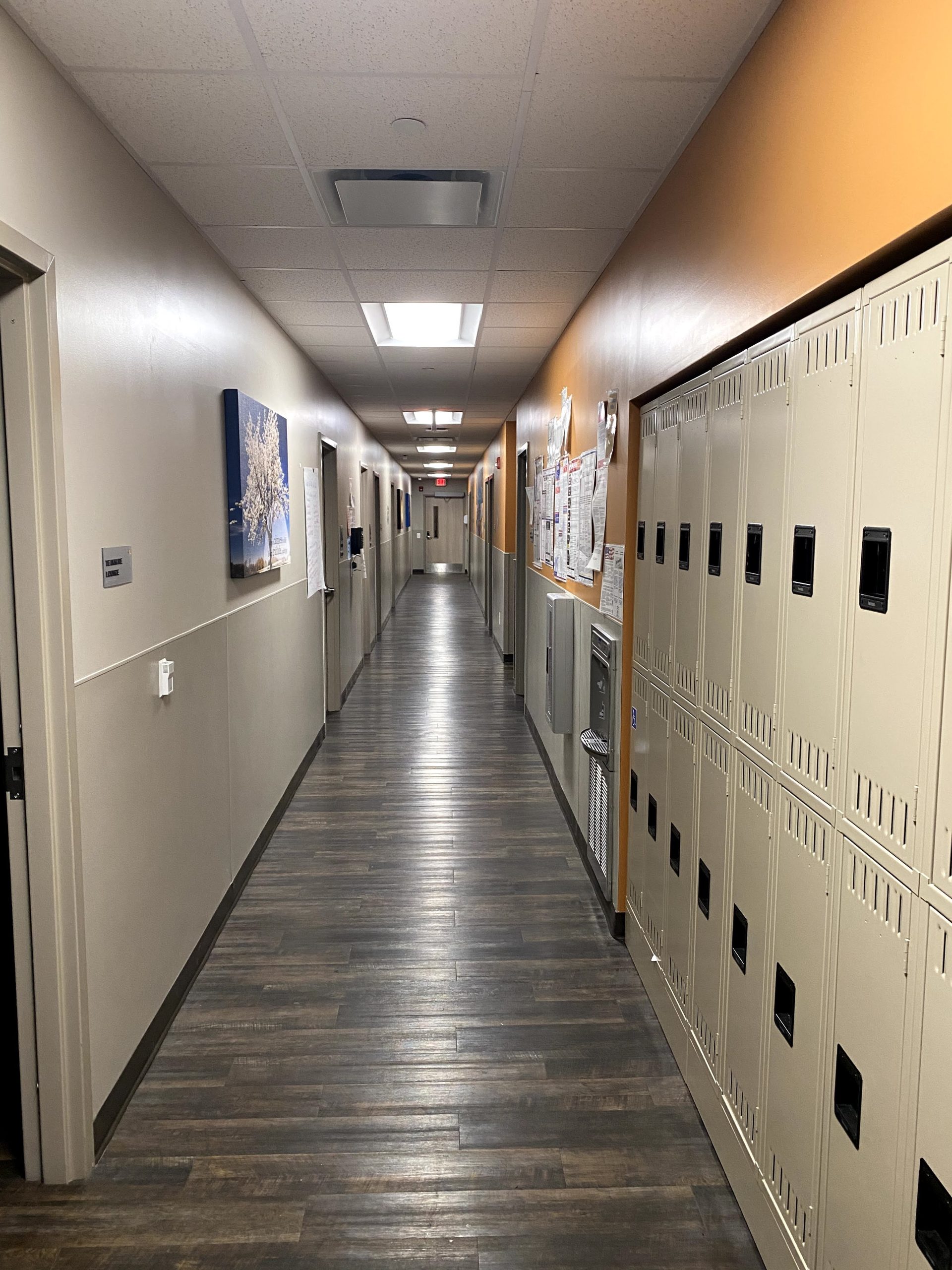 Clean facility hallway with polished floors and lockers